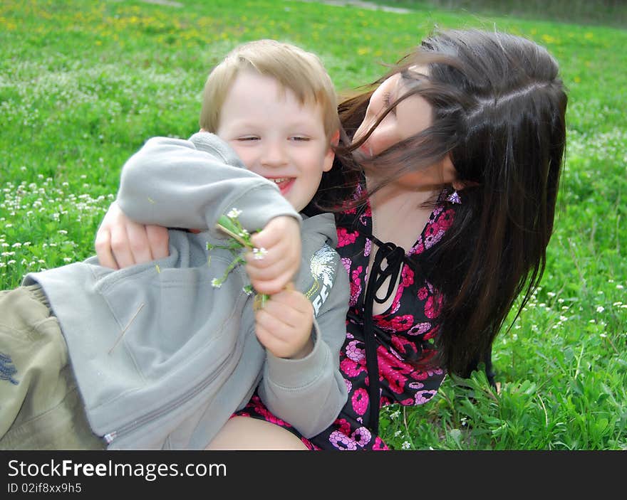 Mum and the son on a walk in the meadow