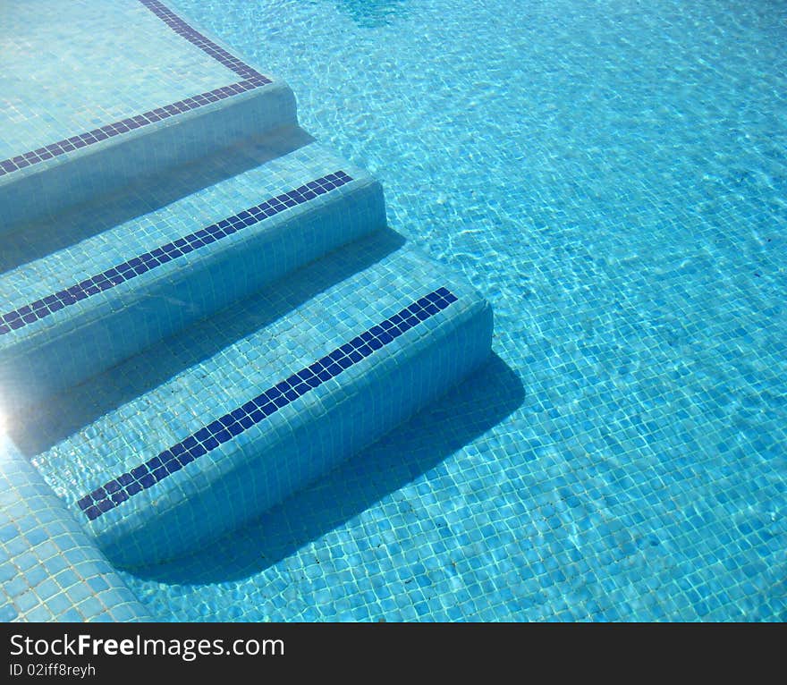 A view on blue clear water in a pool. A view on blue clear water in a pool