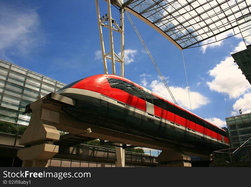 Modern red monorail train above ground. Modern red monorail train above ground