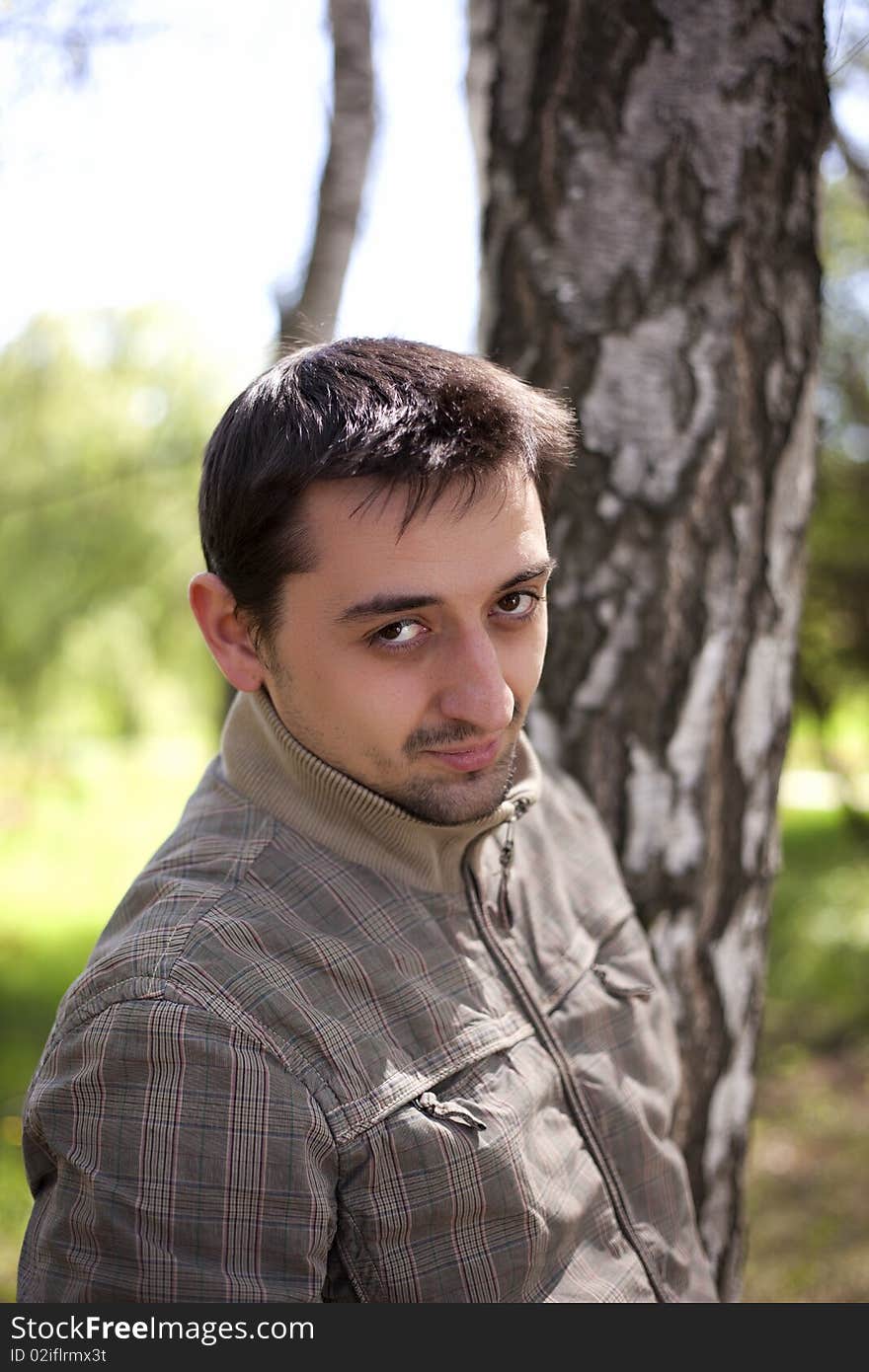 Cute young man posing in a forest. Cute young man posing in a forest