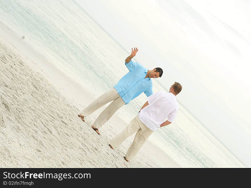 Male Models Talking On The Beach