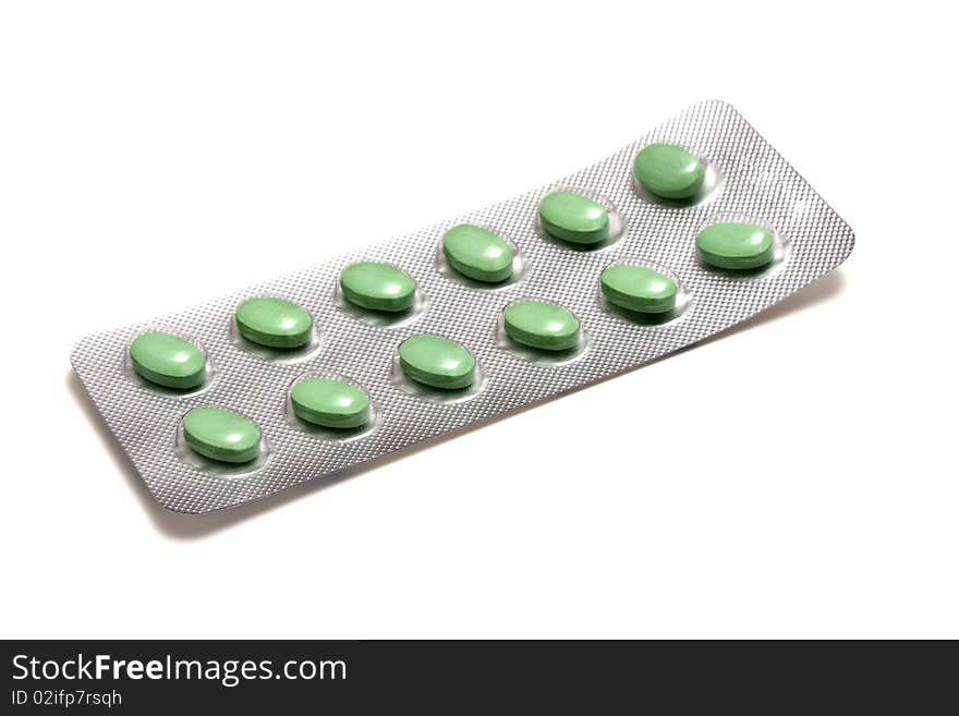 Set of green pills isolated on white background