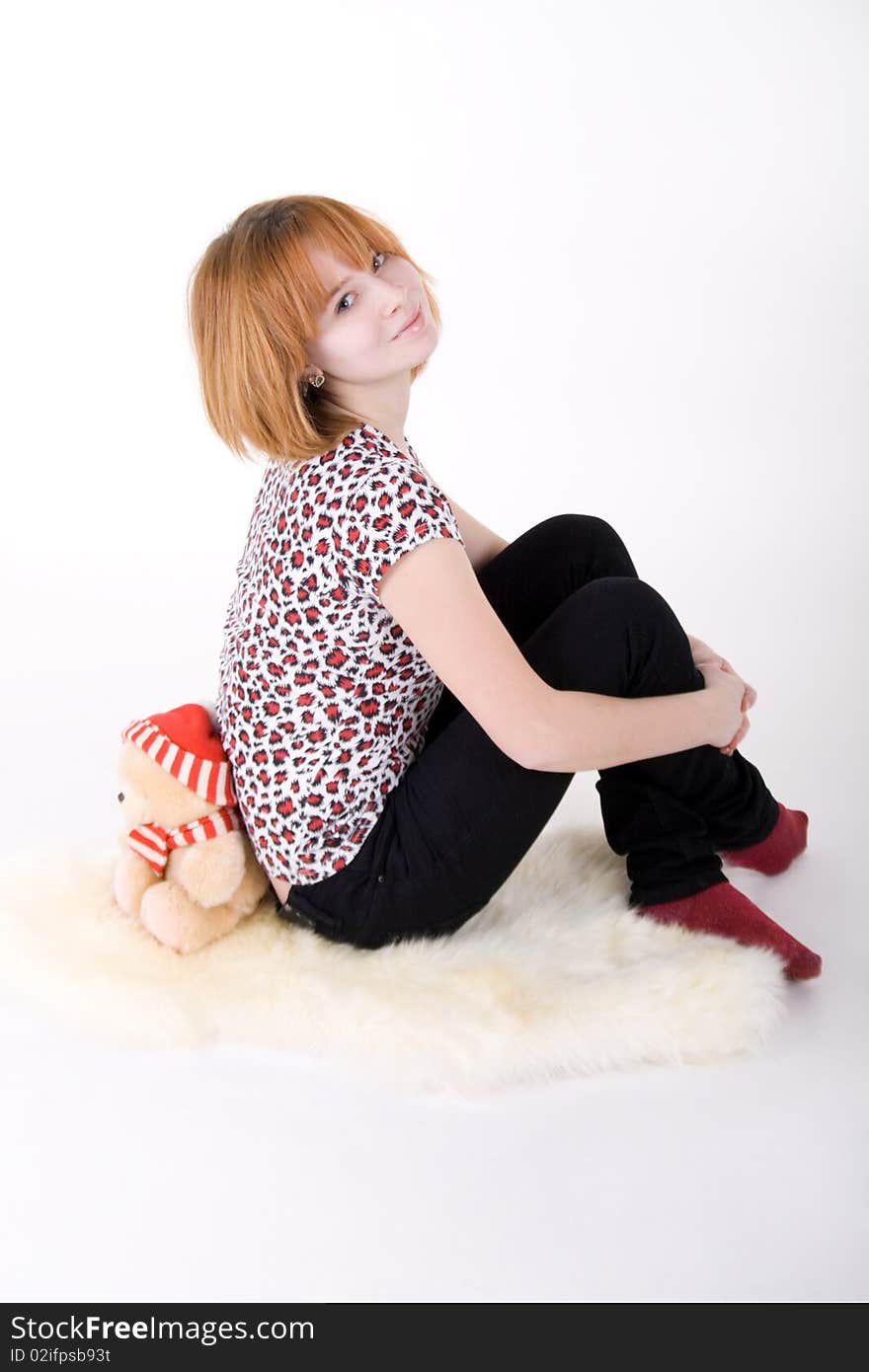 Funny girl and teddy-bear studio shot