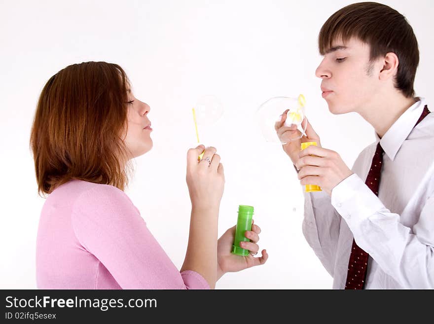 Romantic couple blowing soap bubbles