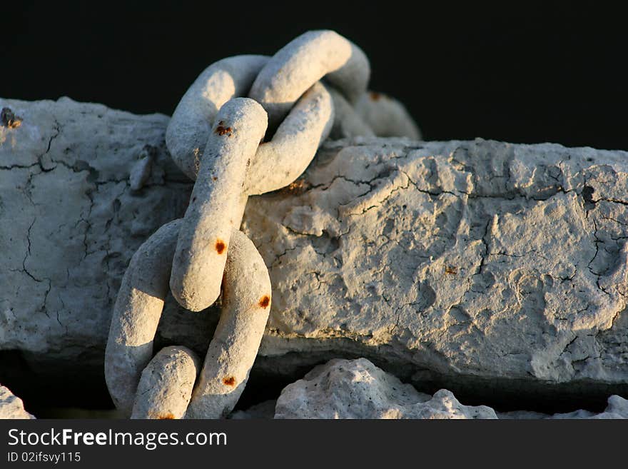 Old muddy boat chain on a dock. Old muddy boat chain on a dock