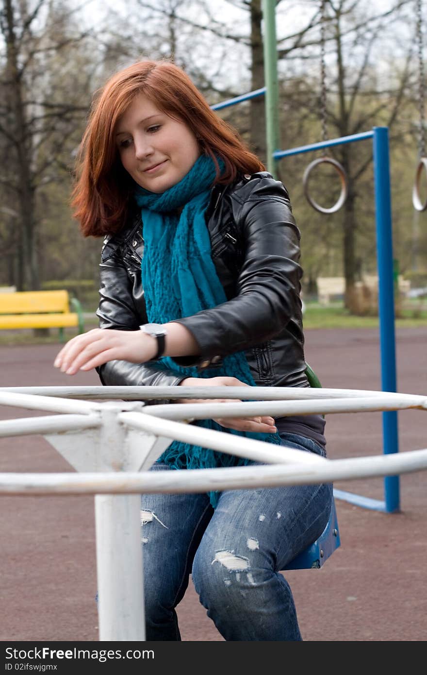 Sportive girl riding carousel