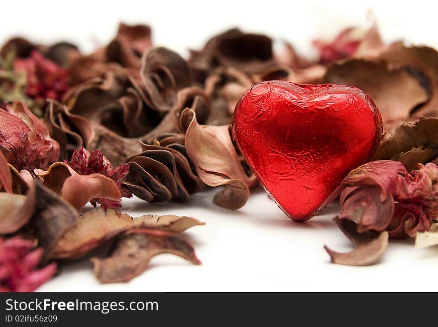 An image of a chocolate with heart shape whit plants decorations. An image of a chocolate with heart shape whit plants decorations