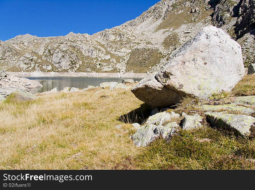 Big stone ind Aiguestortes National Park - Spain. Autumn day. Big stone ind Aiguestortes National Park - Spain. Autumn day