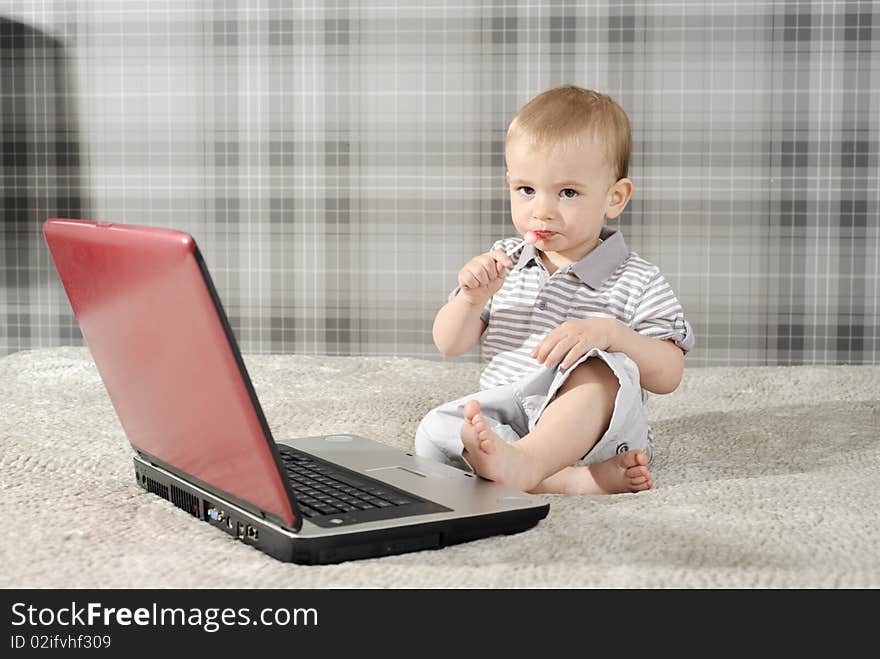 Boy with lollipop and laptop