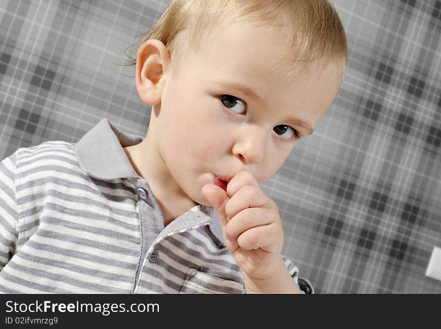 Little boy eating his lollipop and looking at the camera. Little boy eating his lollipop and looking at the camera