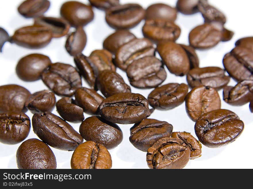 Coffee grains over white background