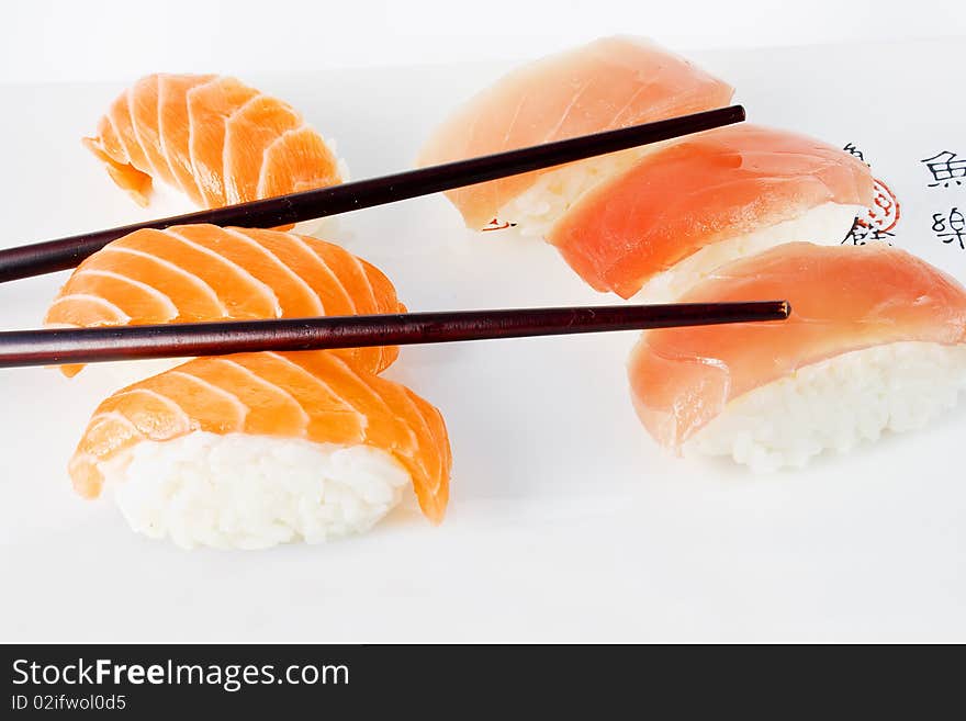 Salmon and tuna sushi with chopsticks