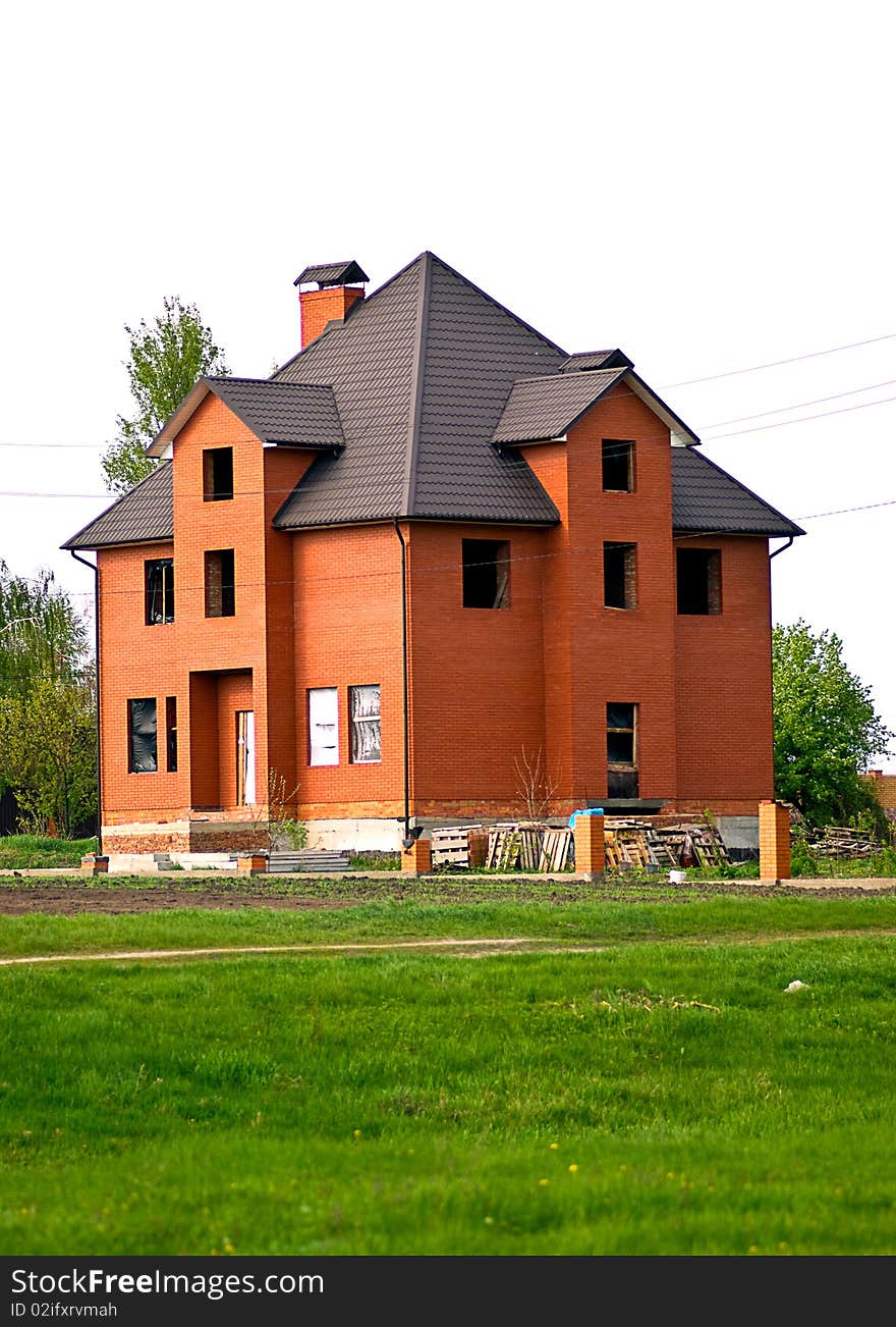 A new home under construction in an unfinished suburb. A new home under construction in an unfinished suburb