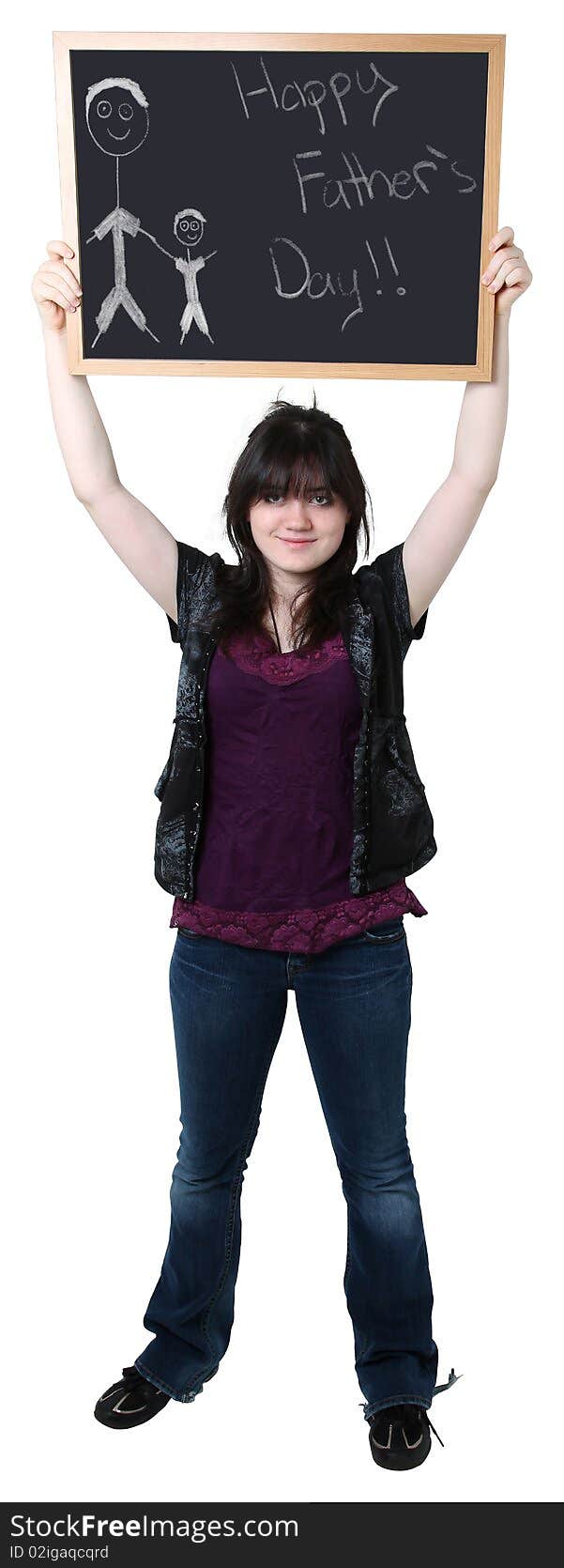 Beautiful sixteen year old teen holding up chalkboard with Happy Father's Day drawing.