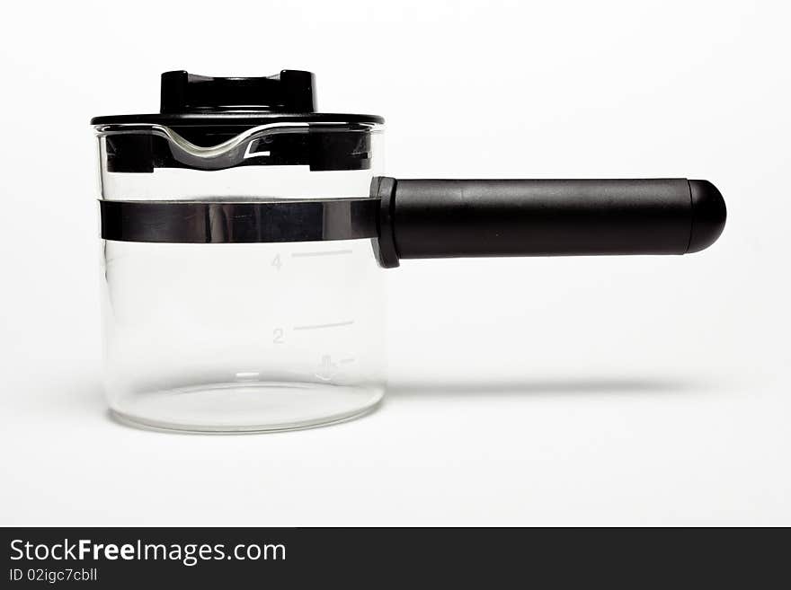 Home espresso / cappuccino milk frothing jug isolated against white background.