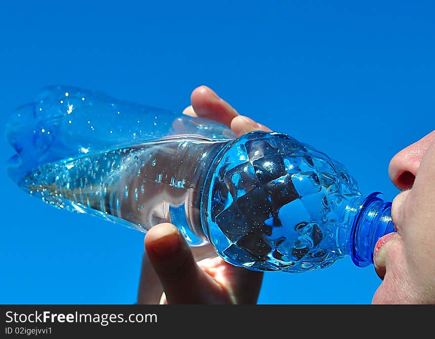 Water. Girl drinks from the bottle in order I thirst to satisfy.