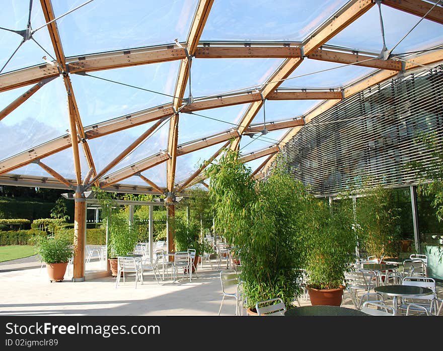 Modern canopy/roof made of wood and plastic above a picnic area with bamboo plants. Modern canopy/roof made of wood and plastic above a picnic area with bamboo plants