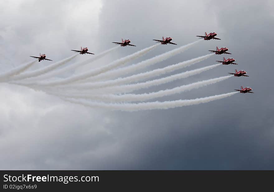 Nine red airplanes flying in formation. Nine red airplanes flying in formation