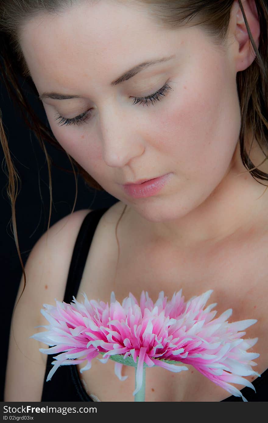 Pretty woman with a large pink flower. Pretty woman with a large pink flower