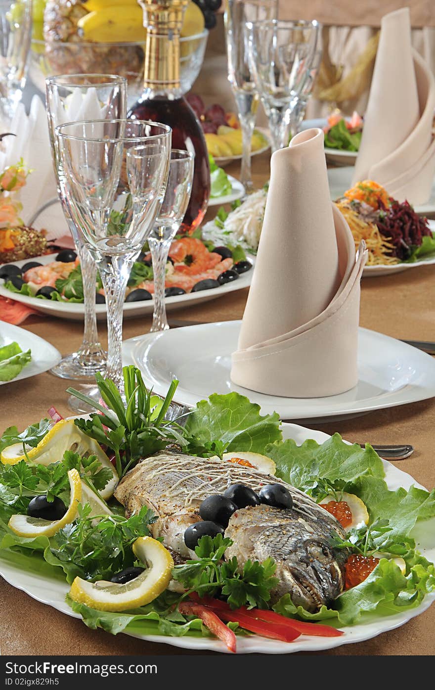 Table served in a restaurant with fish on a foreground. Table served in a restaurant with fish on a foreground