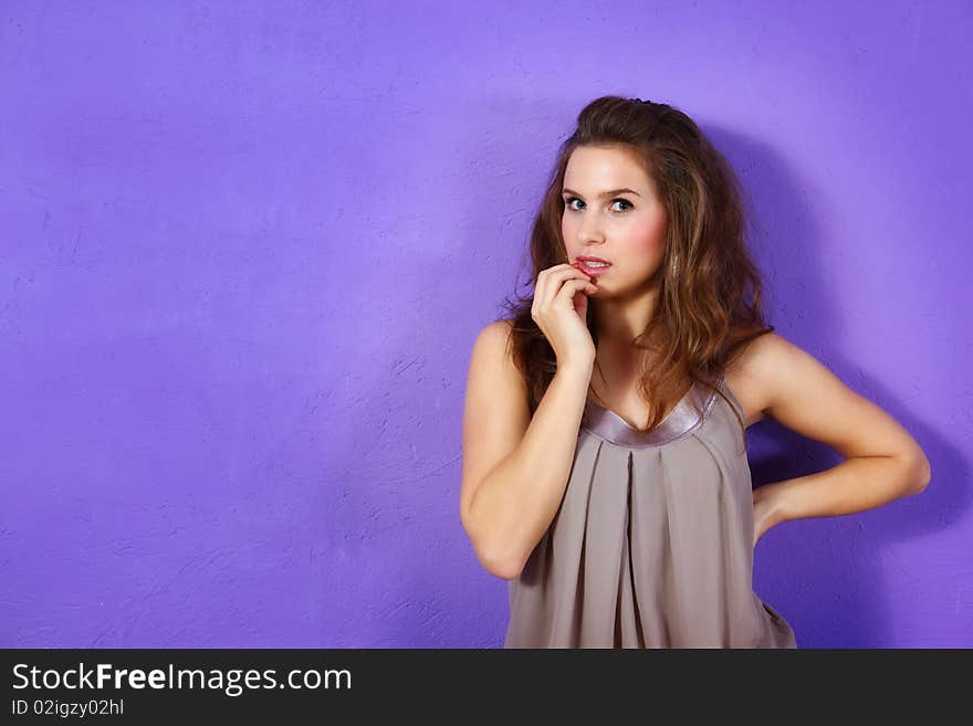 Beautiful woman wearing beige dress and lilac glit