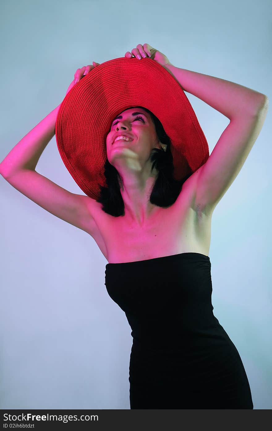 Portrait of young elegant woman wearing black dress and hat with happy expression. Portrait of young elegant woman wearing black dress and hat with happy expression