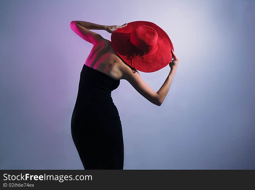 Leaning stylish lady wearing dress and hat