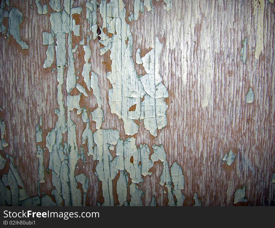 The peeled paint on a wooden surface