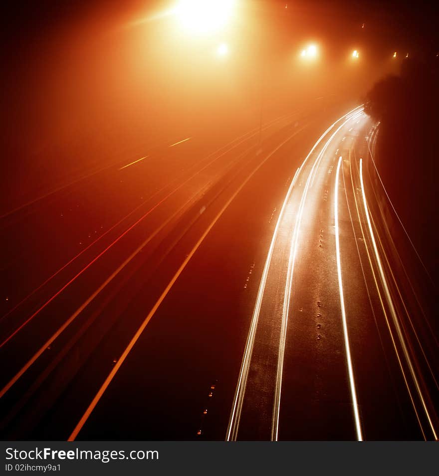 Cars on the highway on a misty night. Cars on the highway on a misty night