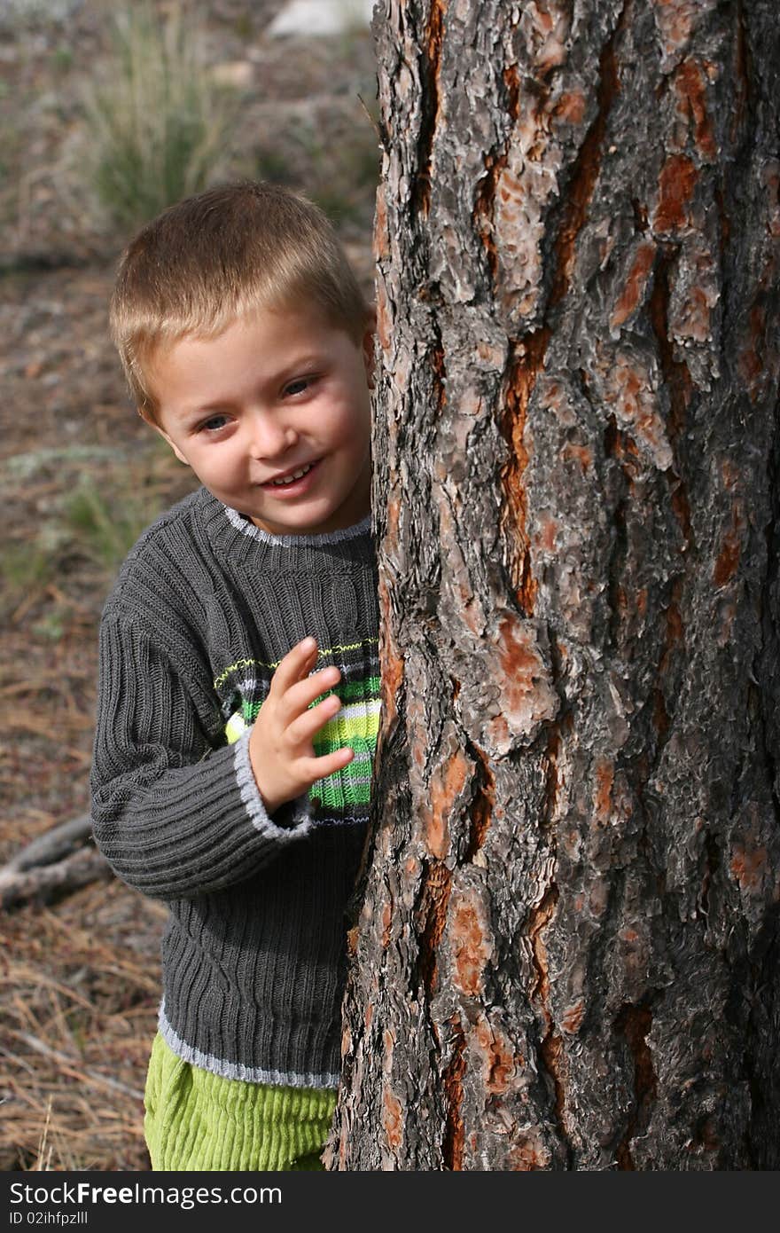 Beautiful blond boy playing outdoors on a spring day