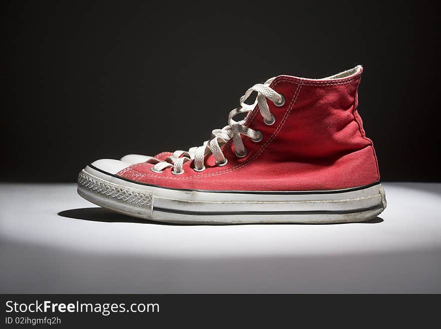 Brand new red sneakers on white background