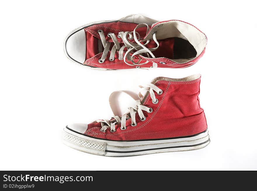 Brand new red sneakers on white background