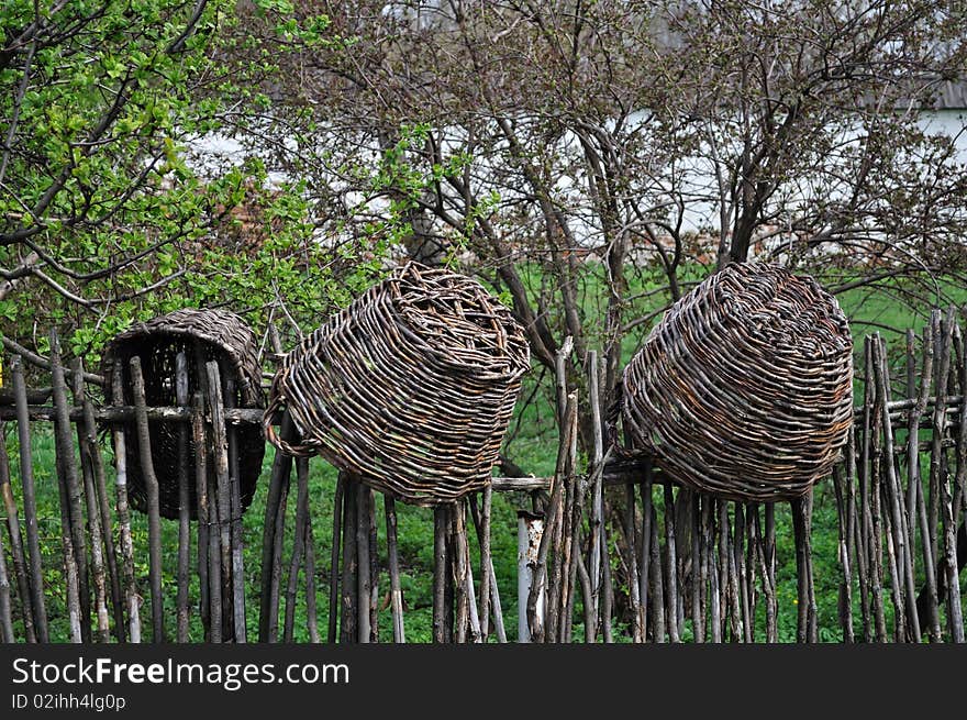 Wicker baskets on wicker fence