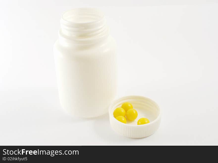 Vitamin C in white cover from vial with vitamins.