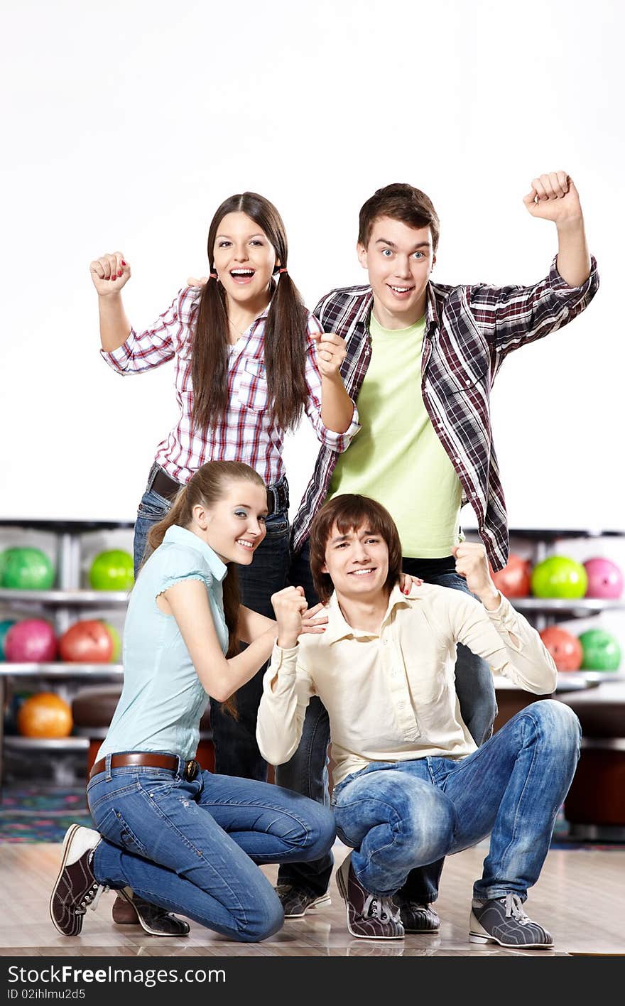 Young attractive people rejoice at game in bowling. Young attractive people rejoice at game in bowling