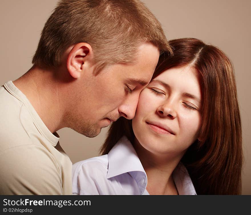 Couple: young man kissing girl