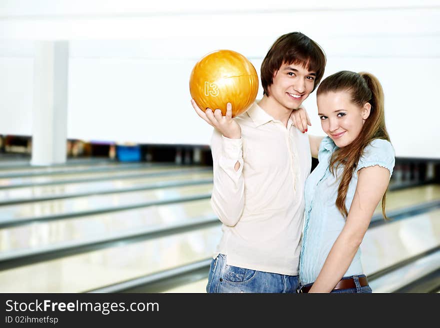 Young couple with a sphere for bowling. Young couple with a sphere for bowling