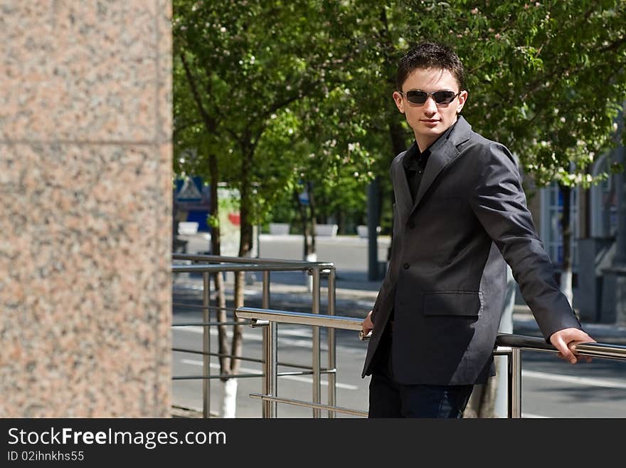 Young businessman in jacket and sunglasses