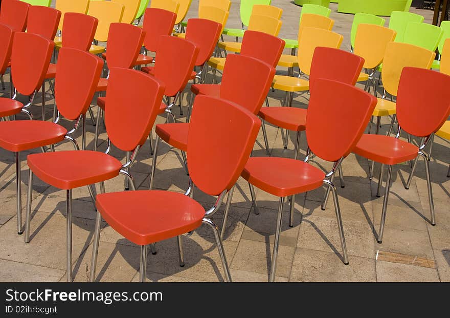 Colored chairs arranged in rows. Colored chairs arranged in rows