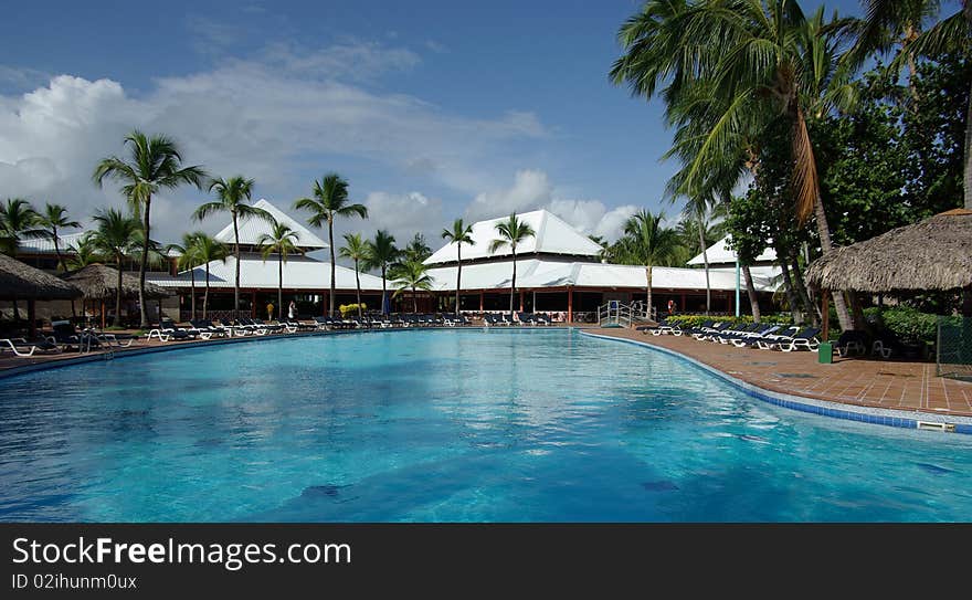 Pool with blue water near a hotel on a tropical resort. Pool with blue water near a hotel on a tropical resort