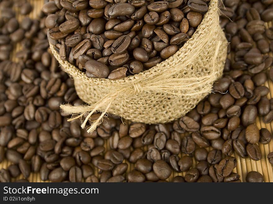 Coffee beans are in the bag and scattered on the table