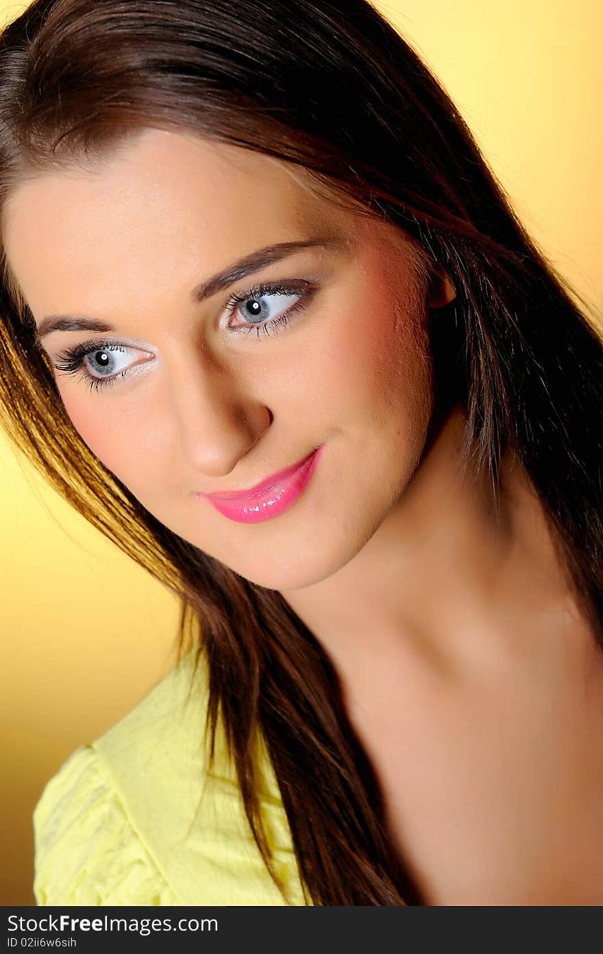 Portrait of pretty relaxed woman with natural make-up. yellow background