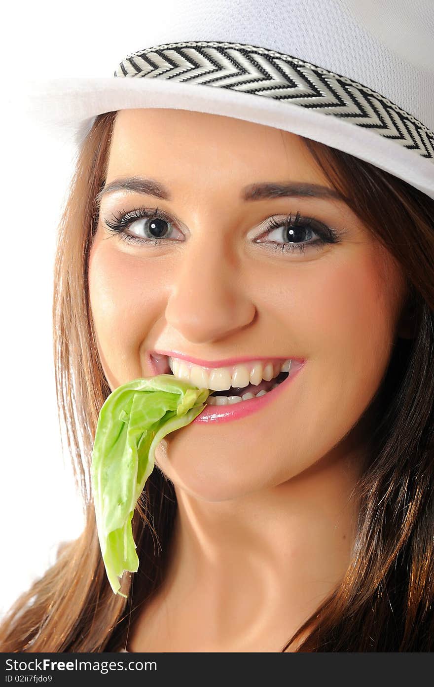 Young pretty woman eating green salad leaf . isolated on white background