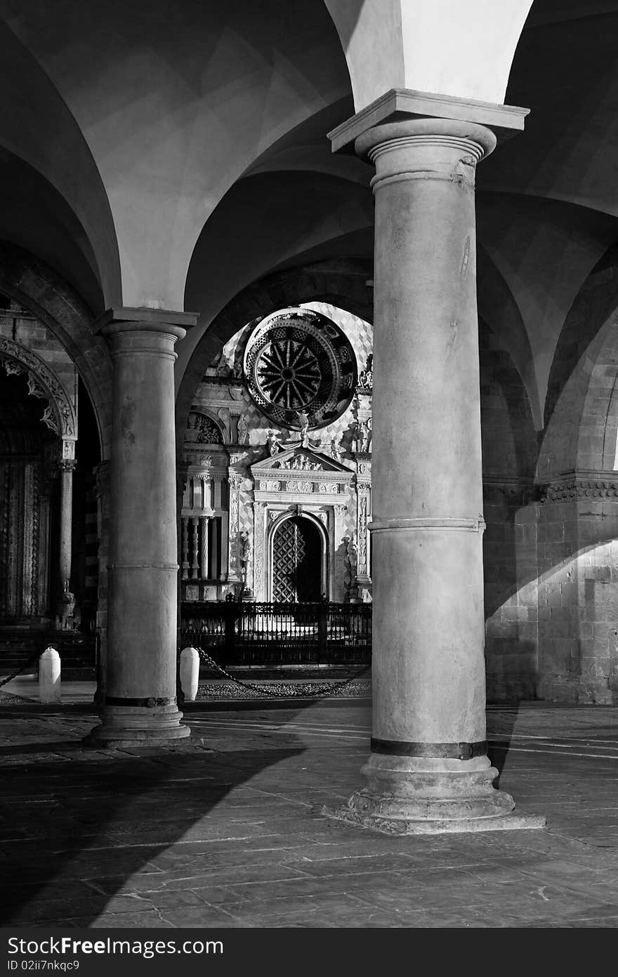 Column, church and palace at night in Bergamo city, at night. Italy.