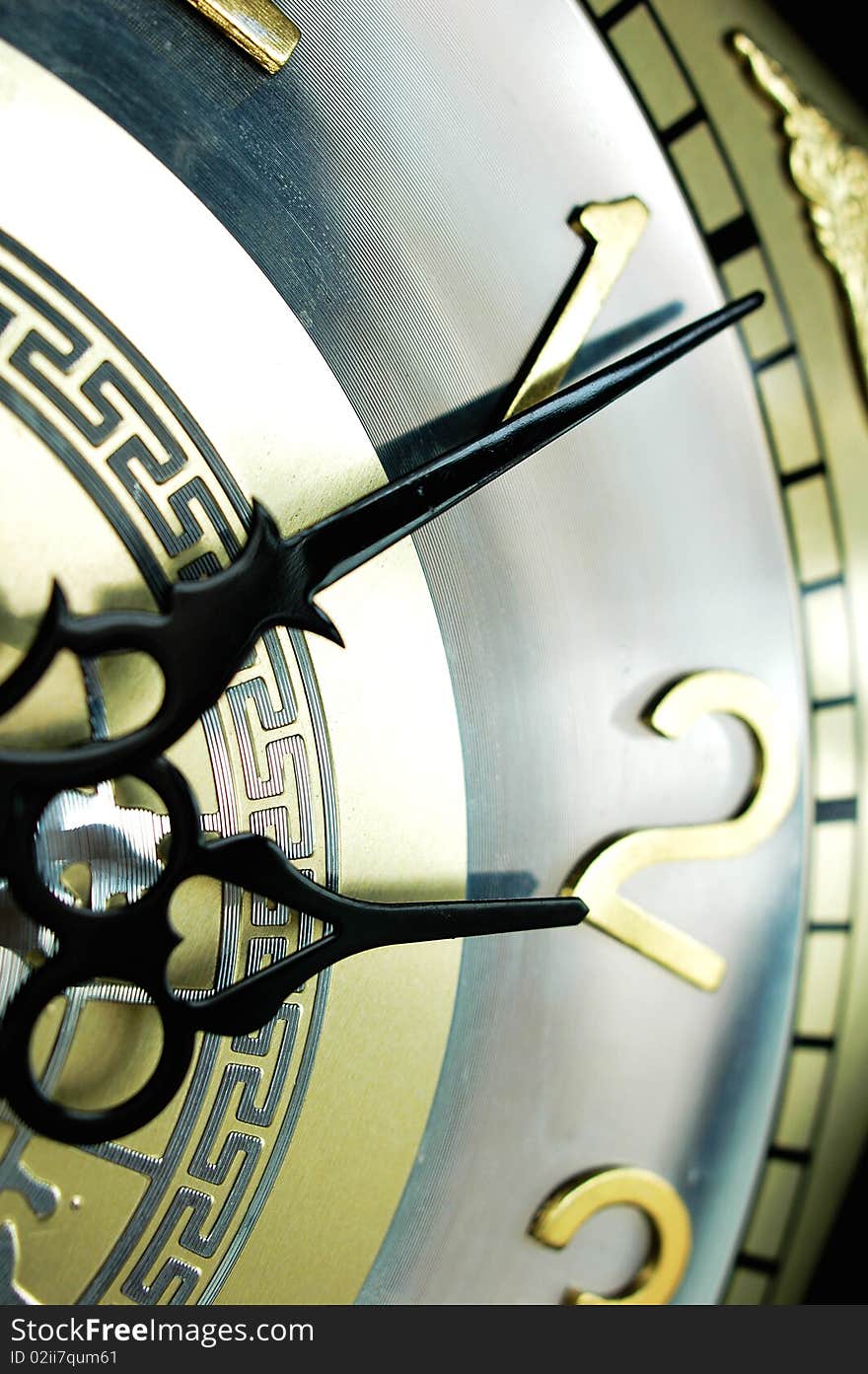 Closeup view of the clock hands of an antique clock