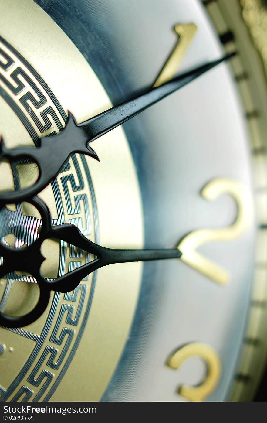 Closeup view of the clock hands of an antique clock