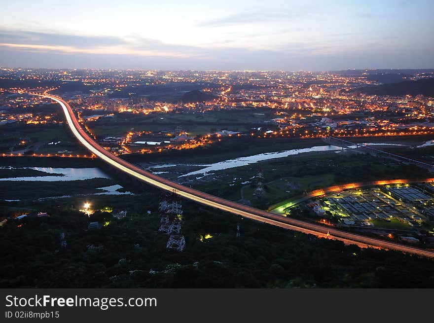 A sunset with a highway in the city