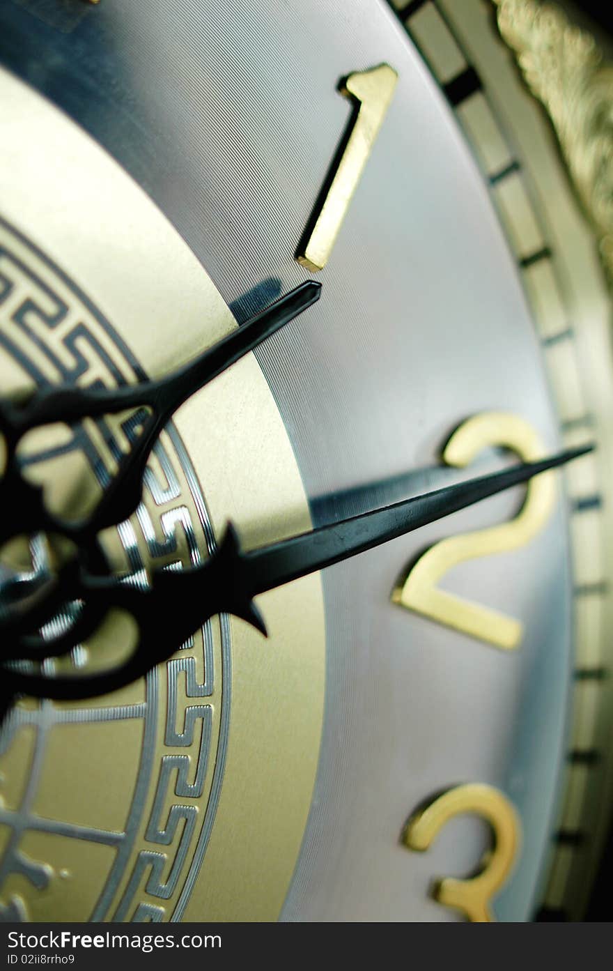 Closeup view of the clock hands of an antique clock