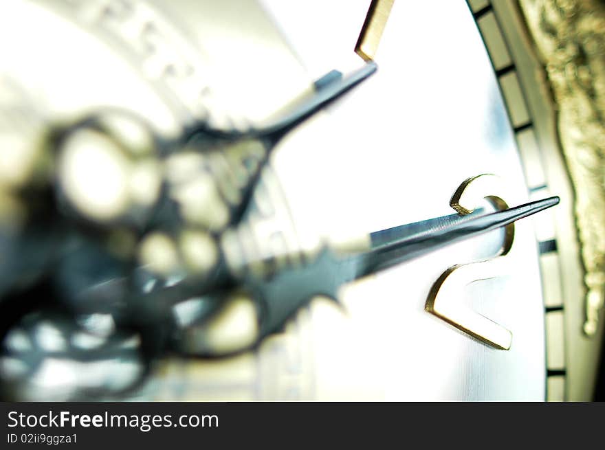 Close view of the hour and minute hands of an antique clock. Close view of the hour and minute hands of an antique clock