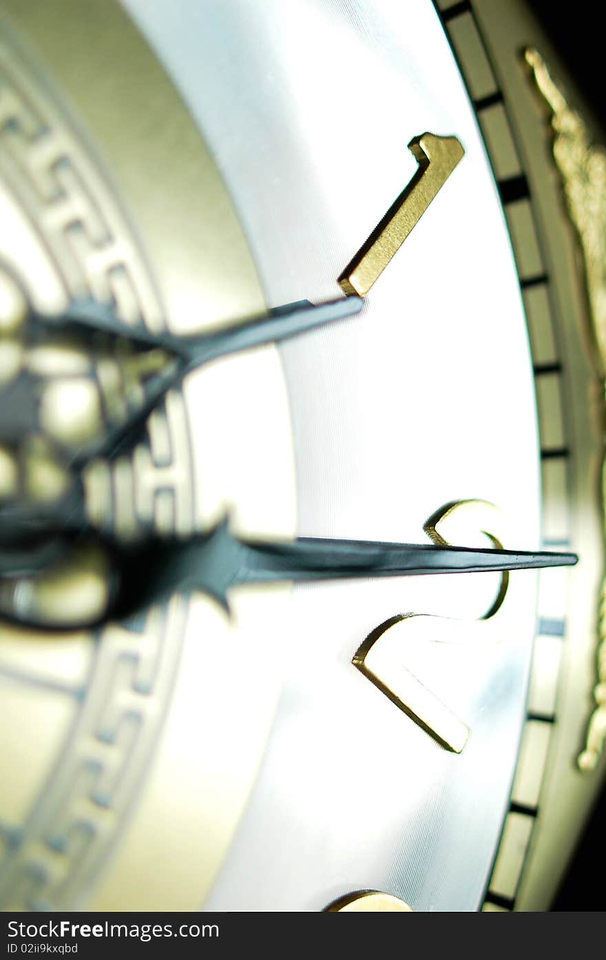 Close view of the hour and minute hands of an antique clock. Close view of the hour and minute hands of an antique clock